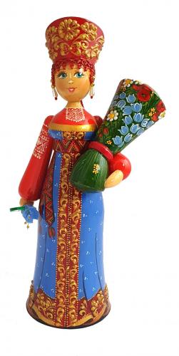 Poupée en costume traditionnel russe avec un bouquet